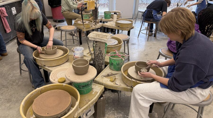 Northfield High School Students work on the pottery wheel during art class.
