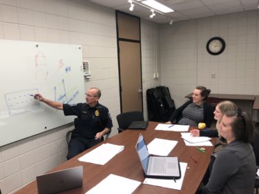 Northfield Chief of Police Monte Nelson discusses different types of glass options that enhance school security with representatives from Wold Architects and Engineers.