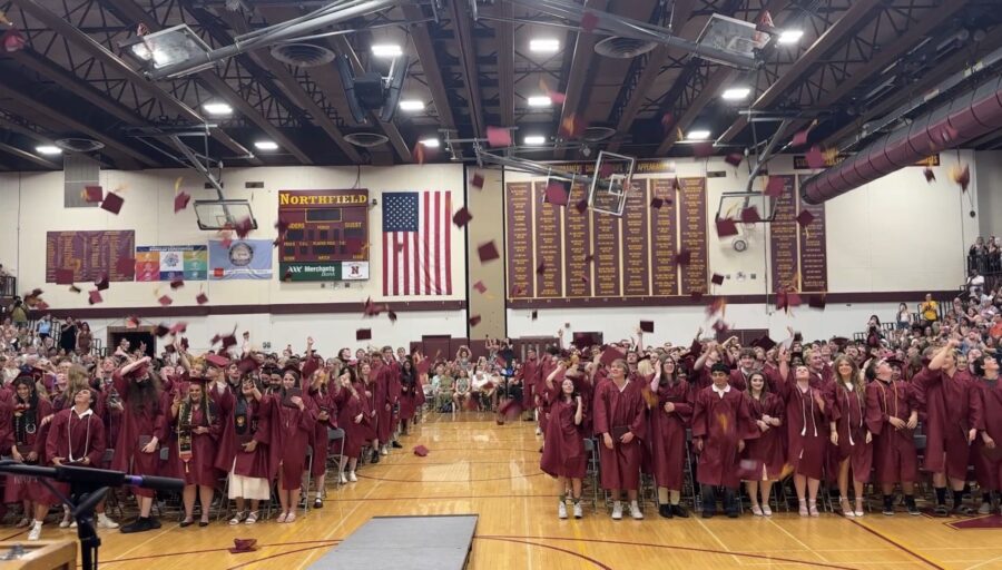 Graduates toss their hats at the 2026 Northfield High School commencement ceremony.
