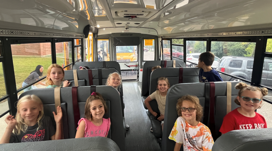 Students sit inside a bus.