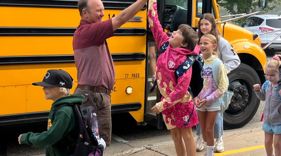 A student gets a high-five from a