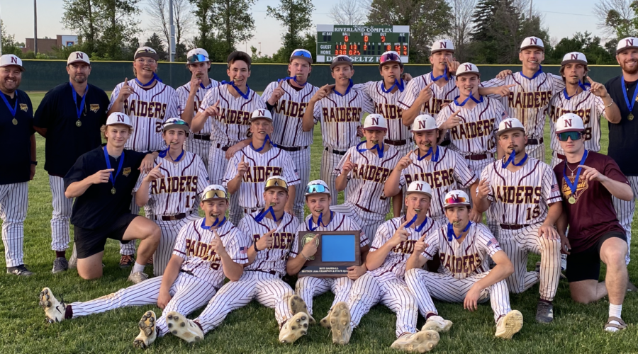 The 2026 Northfield High School Baseball team after winning the Section IAAA championship, advancing them to the state tournament. The team wears metals with blue ribbons around their necks, and hold the championship trophy.