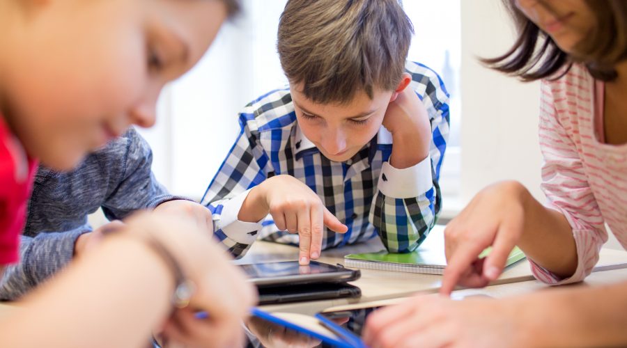 Elementary students working on iPads