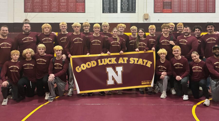 A group photo of the Northfield Wrestling Team holding the 
