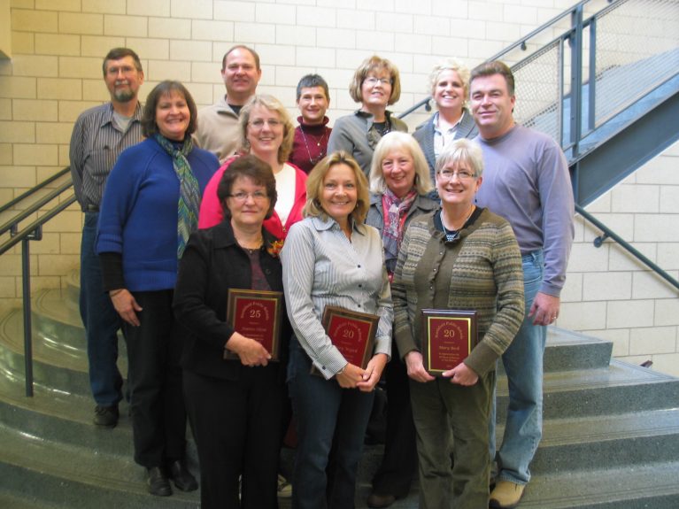 A group of teachers receive the Years of Service award